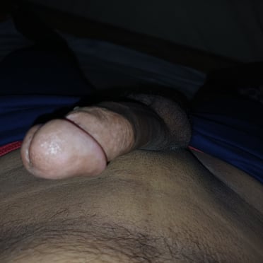 A beautiful, thick, and veiny cock with hairy balls, this pic features a dark-skinned hairy body.