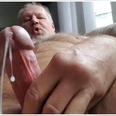 Juicy uncut cock dripping with cum, a thick veiny dick from a hairy muscled dude.