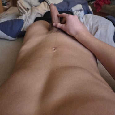 A beautiful, thick cock with light pubic hair, a muscled dude's abdomen peeks through this pic.