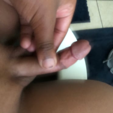 A beautiful, juicy black cock with nicely shaped balls in a close-up pic.