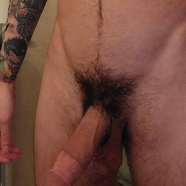 Thick, veiny cock with hairy pubes and cool Batman tattoo, a real beast.