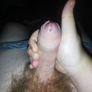 This juicy and thick uncut dick pic features prominent balls and a hairy bush.