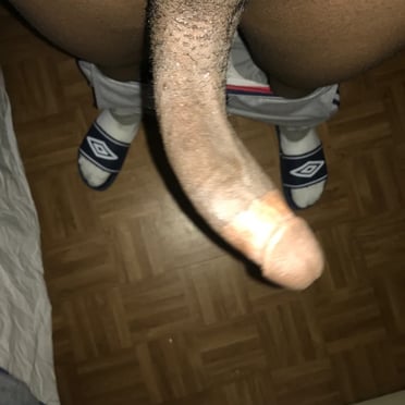 Mouth-watering black uncut dick hangs between hairy balls in an amateur pic.