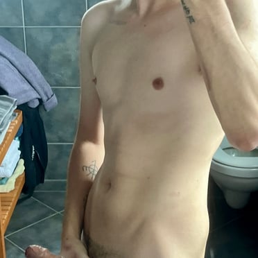 Here is a description for the image:
A thick, juicy cock with prominent veins rests in the hand of a muscled stud.