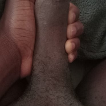 A beautiful, thick, black dick pic with light pubic hair and a muscular build.