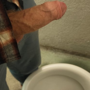 Amateur pic of a veiny average sized cock hovering over a toilet bowl, ready to get drained.
