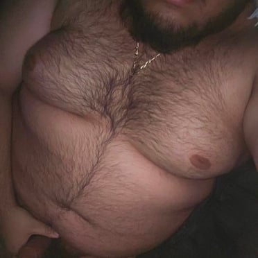 A thick, hairy chest leads to a beautiful, juicy cock ready for action in this close-up pic.