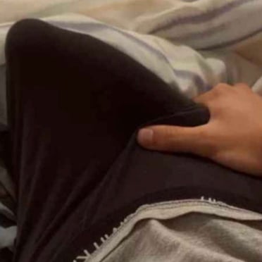 A thick 19cm dick beneath dark pants, showcasing a generous bulge.