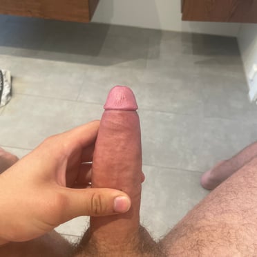 A beautiful, thick, 18cm cock hangs with a well-groomed bush of hair, perfect for hairy cock pics.