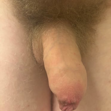 A thick, juicy cock with a full bush of pubic hair is featured in this Canadian dick pic.