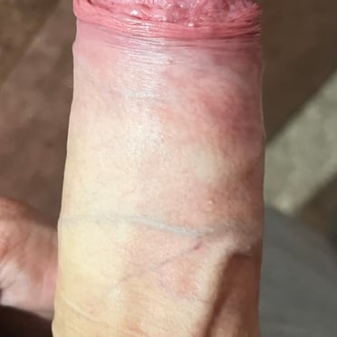 A thick, veiny, pink cock with a prominent head, captured in a close-up pic.