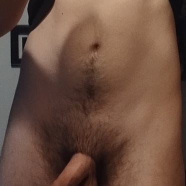 A beautiful, thick uncut cock with hairy balls and a muscled dude.