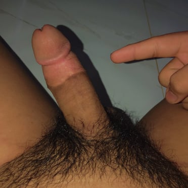 A beautiful, juicy cock with a thick shaft and dark, bushy pubic hair, 5 inches long.
