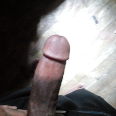 A beautiful, thick, dark dick pic with lightly trimmed pubic hair.