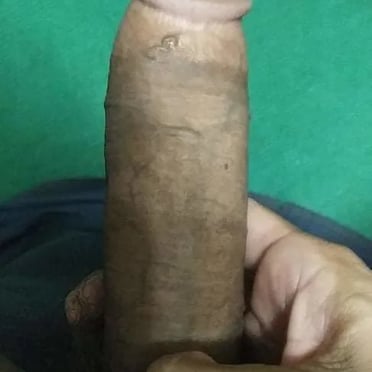 Here's the alt text for the image, optimized for a gay porn website's Myanmar section:

A thick, dark skinned cock is held with a hand, showing off it's meaty shaft and juicy head.
