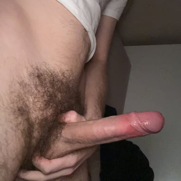 A beautiful, juicy 17cm long Australian cock, ready to make you moan, is proudly displayed with its bushy pubes in this photo.
