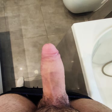A thick, juicy dick pic featuring a beautiful, veiny cock ready for action, with some light pubic hair.