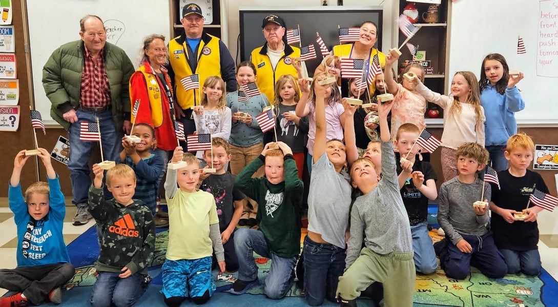 Ennis Lions with Ennis First Grade Students