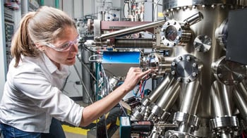 Image of a person checking on manufacturing equipment