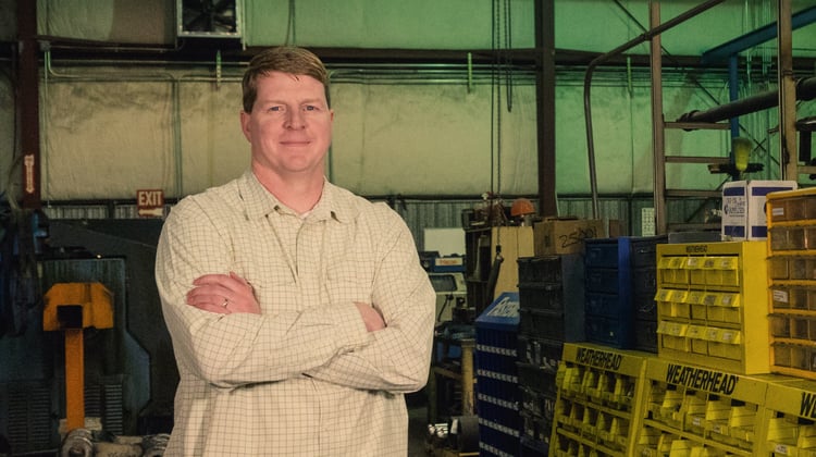 person standing in warehouse next to sorting bins