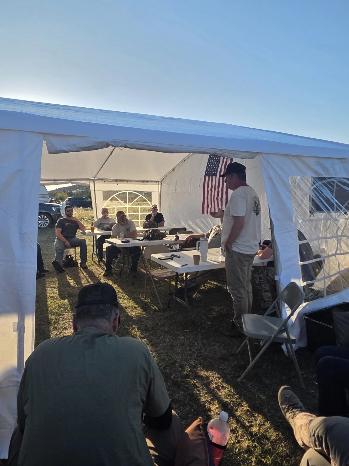 Participants gathered in the open camp tent
