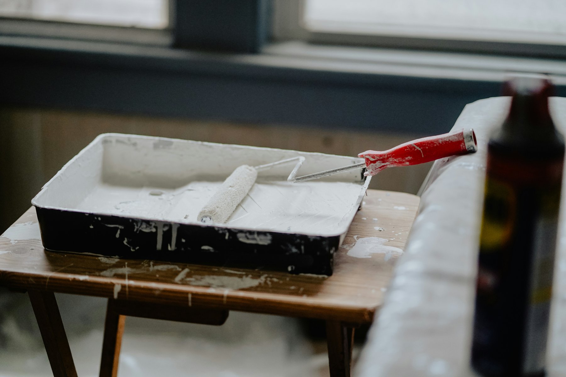 Paint roller in a paint tray