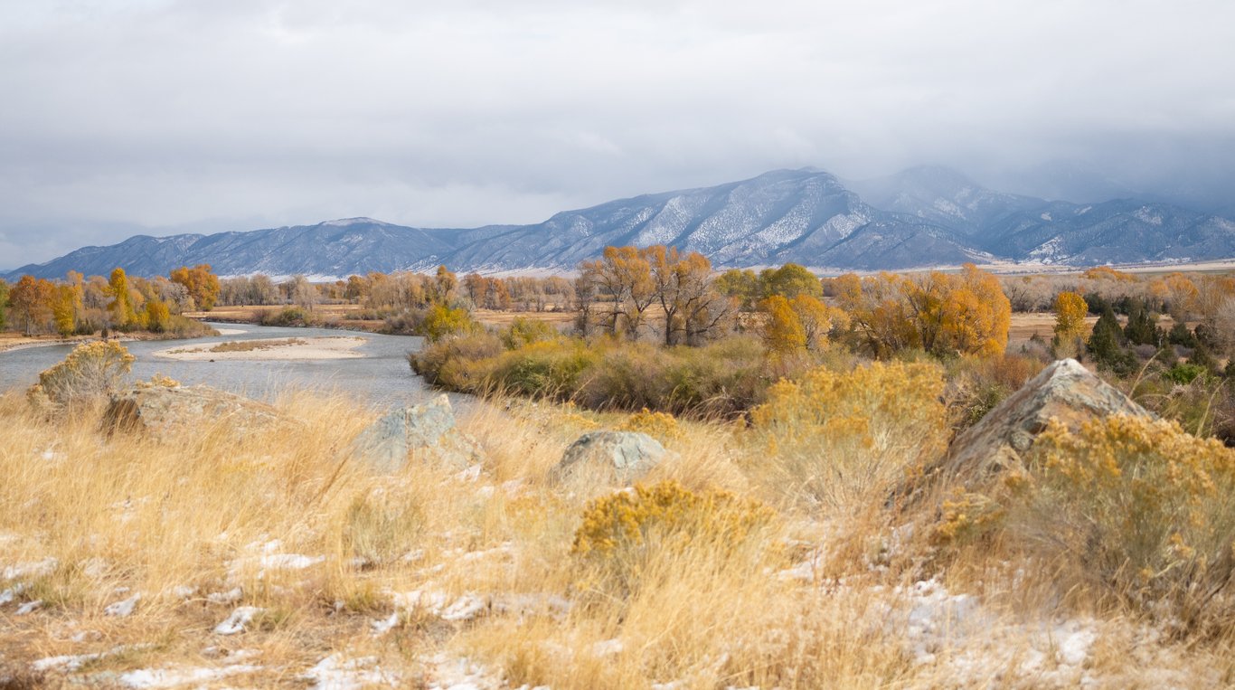 The Beaverhead River and Blacktail Mountains in Montana in the autumn beneath blustery skies