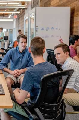 People talking in an open office setting