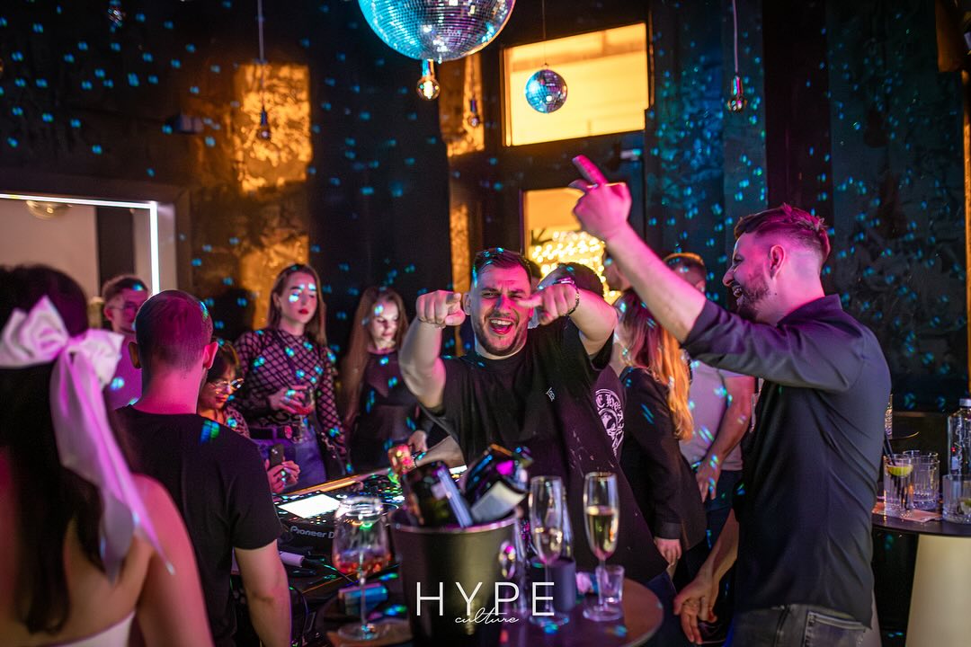 Lively party scene with dancing people and disco ball