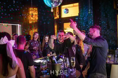 Lively party scene with dancing people and disco ball