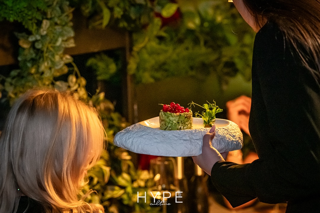 Chef serving a beautifully presented dish