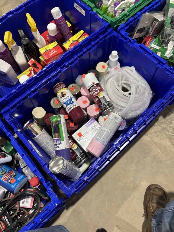 Tote with spray paint, hose, grout, misc