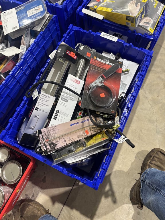 Tote of bungee cords, filter wrenches, shower handles, string lights, etc