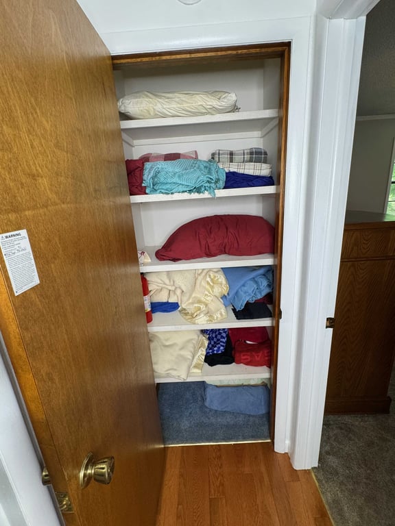 Closet with misc blankets, pillows, towels, etc