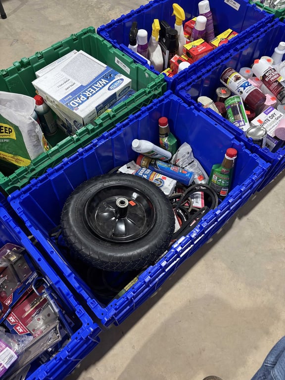 Tote with wheel barrow tire, belts, liquid plumber, etc