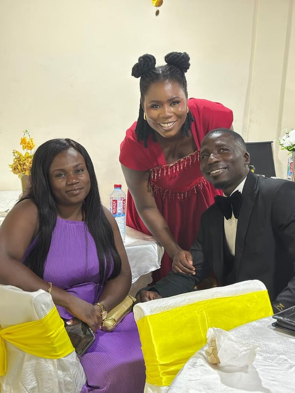 Three church members smiling together at a decorated table during Counselling 101