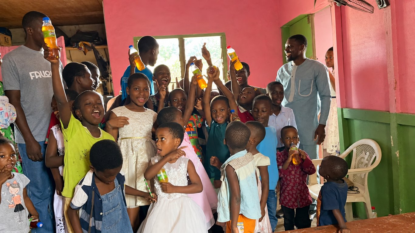 Children and adults posing together in the ministry classroom