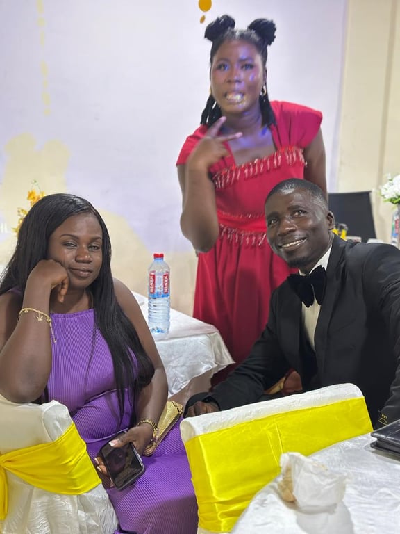 Friends posing playfully at a table dressed in white and yellow