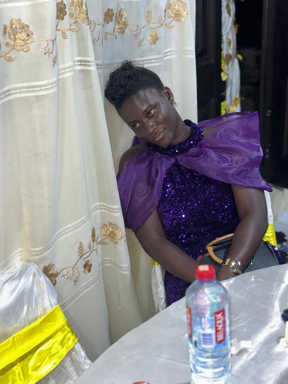 A woman in a purple sequinned dress relaxing at her table