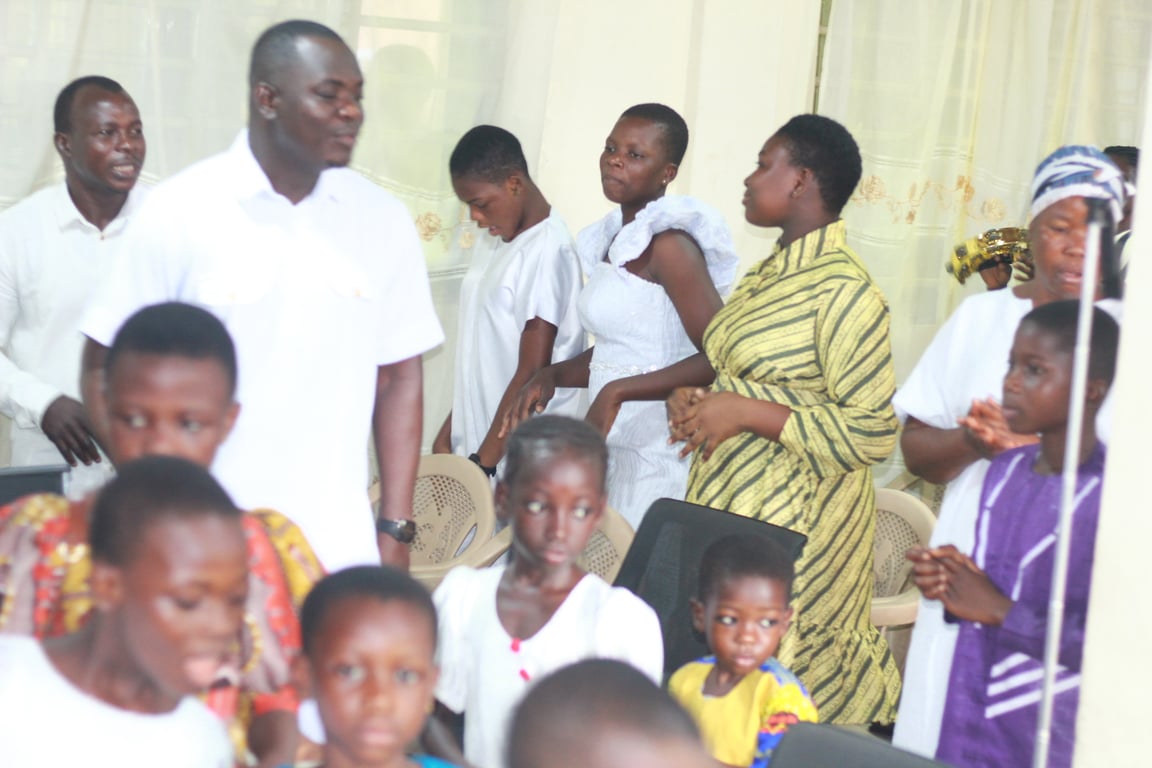 Adults and children gathered together during a church service