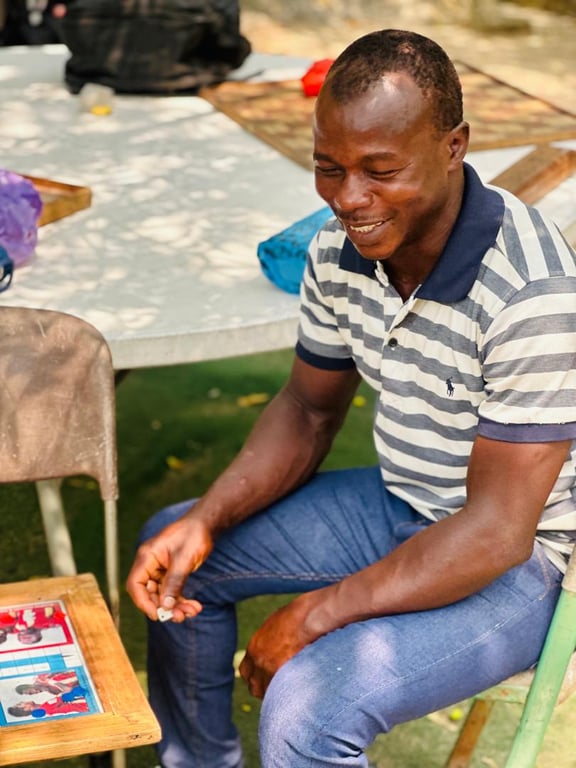 A smiling church member playing a board game at the Love Feast
