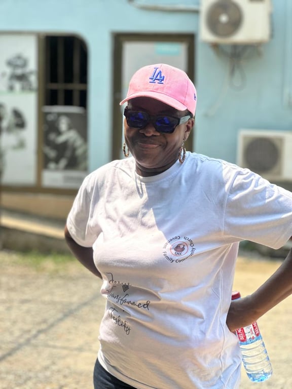 A smiling church member in a CFCC T-shirt at the Love Feast