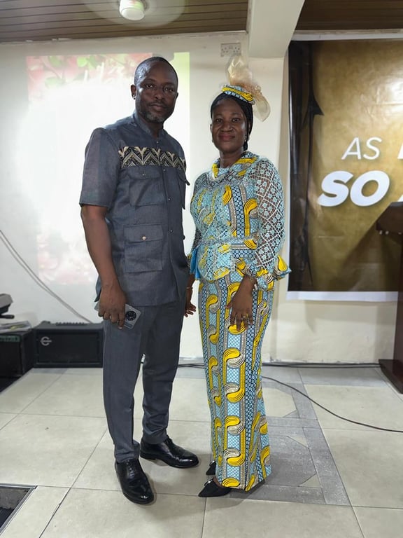 A couple in coordinated attire posing together at the Mother’s Day service