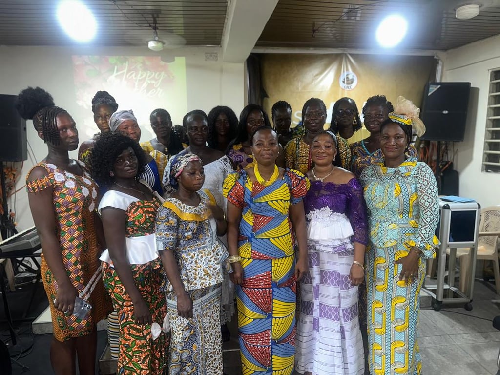 Women of the church posing together in front of the pulpit on Mother’s Day