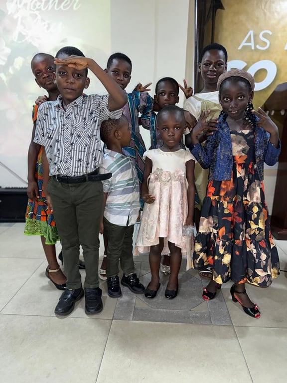 Children of the church posing together in their Sunday best on Mother’s Day