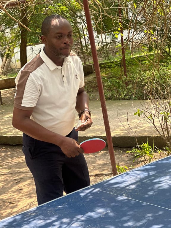 A church member playing table tennis outdoors at the Love Feast
