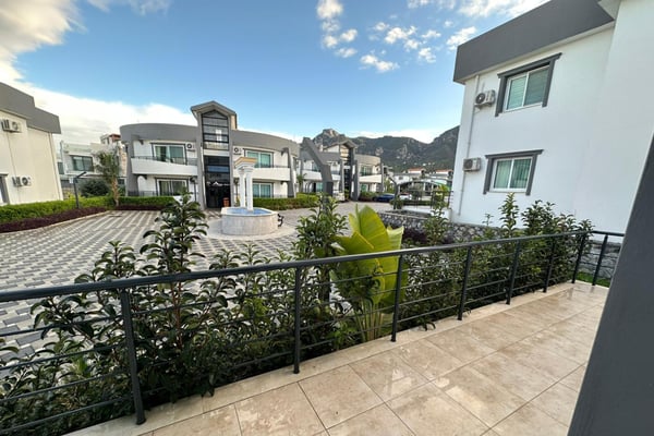 A rooftop terrace invites you to unwind with breathtaking mountain views and cozy lounge seating.