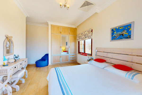 Guest twin room featuring simple decor and sunny outdoor access.