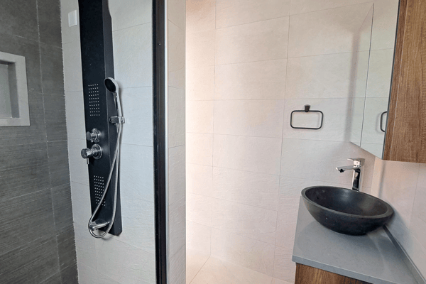 Minimalist powder room with modern fittings and crisp, clean aesthetic.
