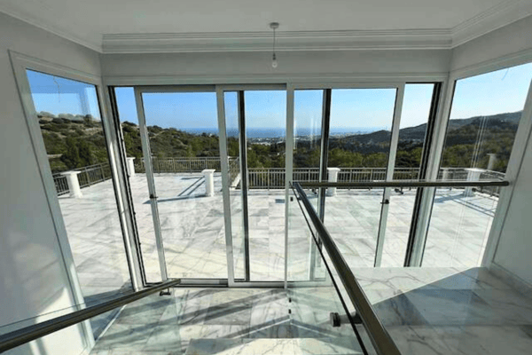Wide glass doors and terrace entry area.